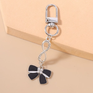 Detail of fashion keychain with rhinestone infinity symbol and black ribbon bow charm