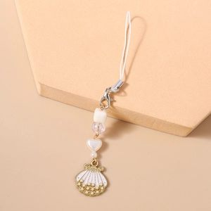 Detailed view of fashion phone strap with white beads, gold shell pendant and small pearls