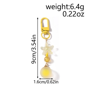 Detailed view of yellow starfish keychain dimensions and glitter beads on white background