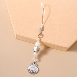 Detail of beaded phone strap featuring white enamel shell pendant and faux pearl accents