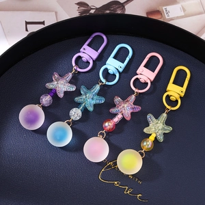 Starfish and matte bead keychains set in purple, blue, pink and yellow colors