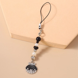 Detail of nautical phone strap with pearls and black striped seashell pendant