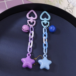 Star charm keychains with heart buckles, bells and plastic chains in purple and blue colors