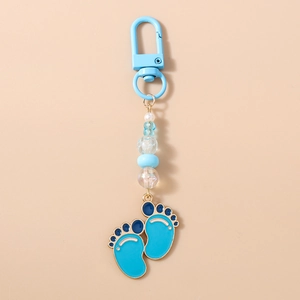 Detailed view of beaded keychain with blue enamel baby footprints and lobster clasp