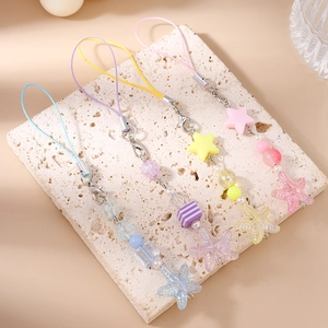 Detail of colorful acrylic bead phone charms with starfish and star pendants