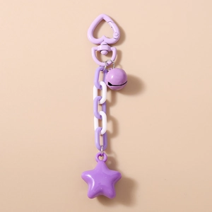 Detail of purple star keychain with heart clasp, plastic chain links, and a small bell