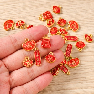 Detailed close-up of red enamel Chinese style pendants for DIY jewelry crafting