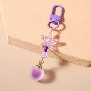 Detailed view of purple starfish keychain with frosted bead and resin pendant decor