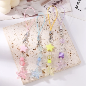 Detail of four striped beaded star and starfish charms in pastel summer colors