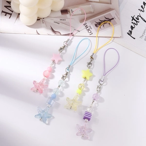 Detailed view of four beaded phone charms featuring starfish and stars in pastel colors