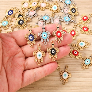 Detail of turtle-shaped evil eye alloy charms with colorful enamel finish for DIY jewelry