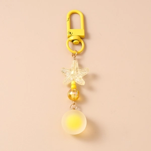Detail of yellow starfish keychain with frosted ball and glossy bead on D-ring clasp