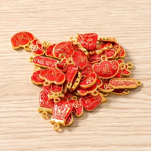 Macro shot of red and gold Chinese lucky bag charms for DIY jewelry making
