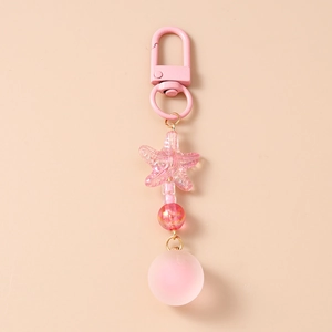 Detailed macro view of pink beaded keychain with frosted ball and star charm
