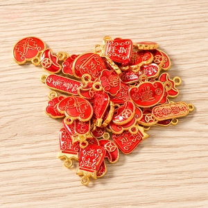 Macro view of Chinese style lucky bag charms with red enamel and golden alloy finish