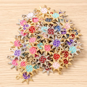 Detail of colorful sun and star enamel charms with spiral patterns for DIY jewelry making