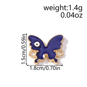 Macro view of blue butterfly enamel charm with evil eye pattern and dual side rings