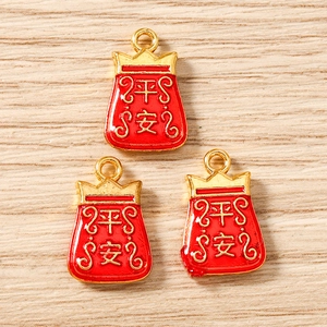 Detail of red Chinese lucky bag charms with gold Pingan text for DIY jewelry making