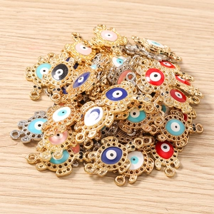 Macro detail of colorful evil eye turtle charms with rhinestone inlay for DIY jewelry