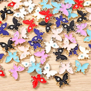 Detailed macro view of colorful butterfly enamel charms with evil eye design for DIY jewelry