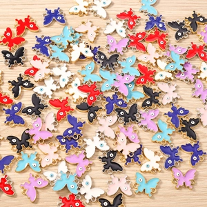 Detailed macro of colorful enamel butterfly pendants with evil eye pattern and double loops
