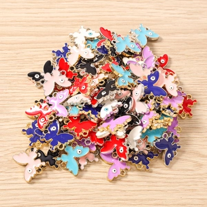 Macro detail of alloy butterfly charms with evil eye design and golden frames for DIY jewelry