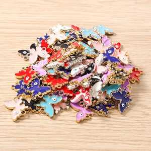 Detail of colorful enamel butterfly pendants with evil eye pattern for DIY jewelry making