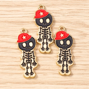 Vue macro de trois breloques tête de mort avec chapeaux rouges pour bijoux DIY