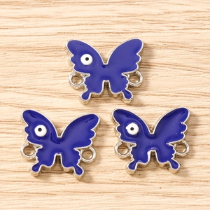 Blue butterfly charms with evil eye detail and silver connectors for DIY jewelry