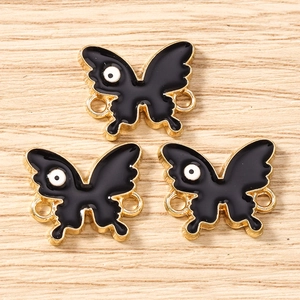 Three black butterfly charms with gold metal borders for DIY jewelry making and crafts