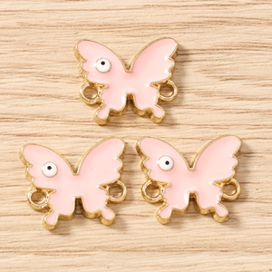 Pink enamel butterfly jewelry connectors with golden metal edges and eye pattern detail