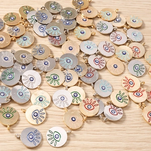 Close-up of colorful enamel evil eye charms with gold and silver metal bases for DIY
