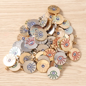 Macro shot of colorful enamel evil eye charms in gold and silver plating for DIY jewelry