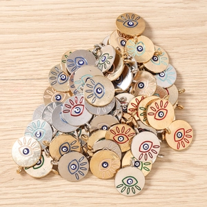 Close-up of colorful evil eye metal charms in gold and silver plating for DIY jewelry
