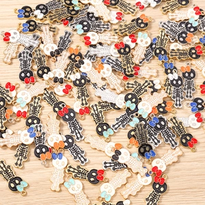 Detailed macro view of mixed enamel skull charms with bows for DIY jewelry making