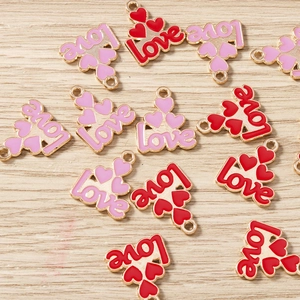 Macro shot of red and pink heart Love charms for DIY jewelry making and craft projects