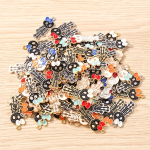 Close-up of bulk skull girl pendants with colorful enamel finish for DIY jewelry