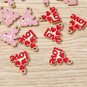 Macro detail of red and pink heart charms with Love engraving and alloy enamel finish