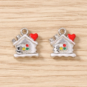 Detailed macro of enamel house pendants with rhinestones and red heart for DIY jewelry