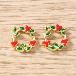 Detail of red berry and green leaf enamel flower wreath charms for jewelry making