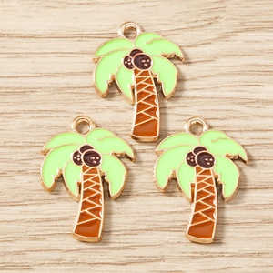 Détail de trois breloques de cocotiers en émail vert avec placage d'or sur bois