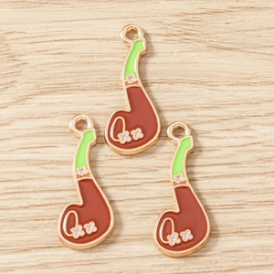 Detailed macro view of three vintage pipe-shaped alloy pendants for DIY jewelry making