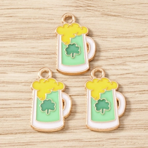 Macro view of St. Patrick's Day beer mug pendants with green enamel and lucky clover