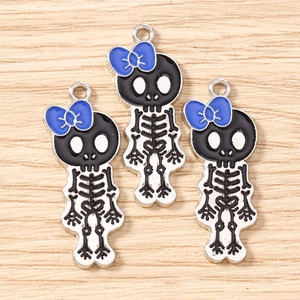 Detailed view of skull girl charms with blue bows for DIY jewelry making and necklaces