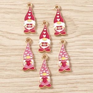 Detail of Christmas gnome alloy charms in red and pink for DIY jewelry making