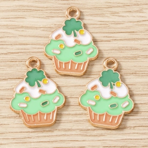 Detailed view of three enamel cupcake charms with St. Patrick's clover for DIY jewelry