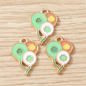 Macro view of three-balloon clover charms with enamel finish for DIY jewelry crafting