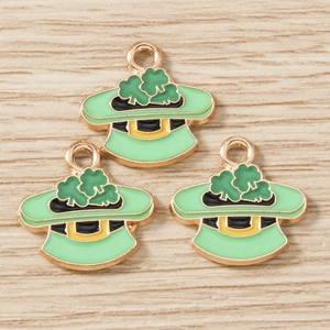Detailed close-up of green St. Patrick's Day hat pendants with clover charms on wood