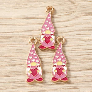 Detailed close-up of three pink enamel gnome charms for DIY jewelry and necklaces