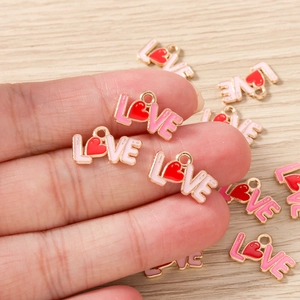 Detail of LOVE letter alloy pendants with red heart for DIY jewelry making